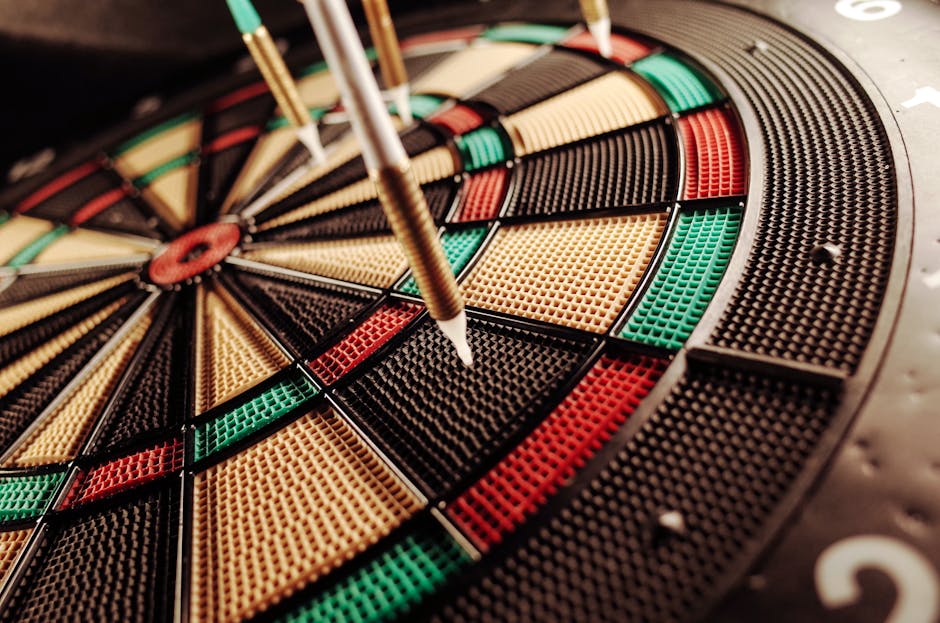 A detailed close-up of an electronic dartboard, showcasing vibrant colors and precision darts hitting the target.